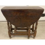 A Victorian drop leaf, gate leg table with turned legs and peg joints.