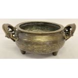 A large vintage Chinese 2 handled censer with decorative dragon shaped handles.