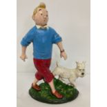 A painted cast iron flat backed door stop, in the shape of Tin Tin and Snowy.