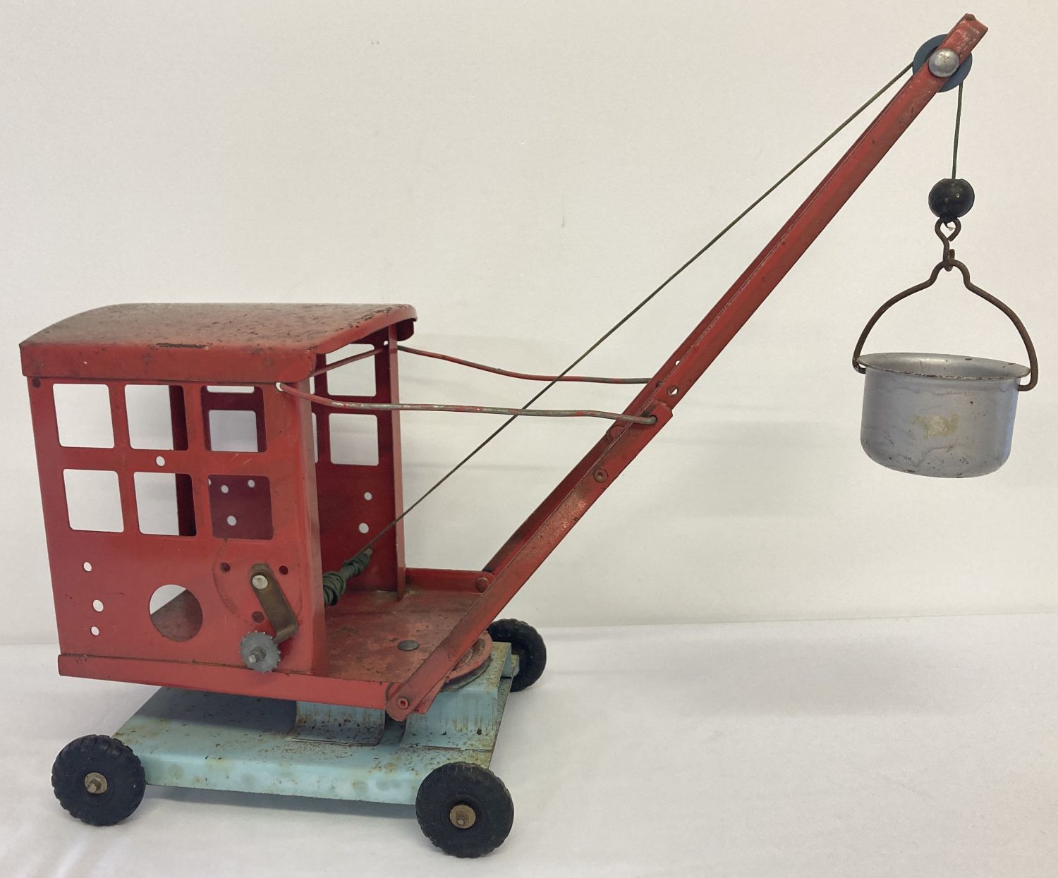 A vintage red and blue 1950's No. 2 tinplate crane with bucket and swivel base by Tri-Ang.
