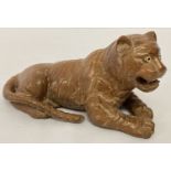 An oriental carved wooden tiger with bone set eyes.