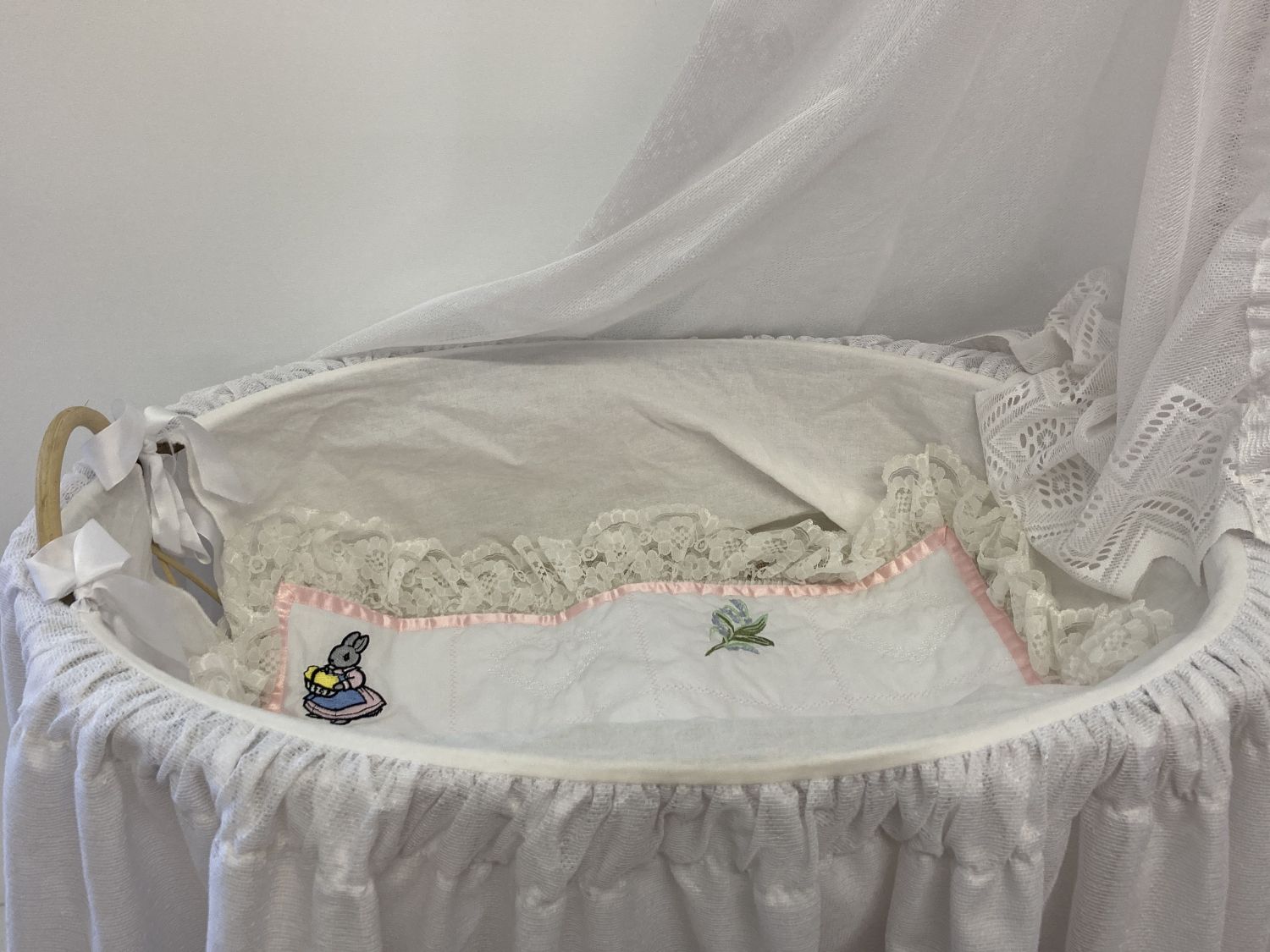 A modern wood and cane dolls crib on wheeled base. Complete with bedding and hanging drapes. - Image 2 of 3