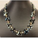 An unusual 18" vintage glass beaded necklace with decorative clasp.