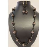 A matching necklace and earrings set made with black Venetian style glass beads.