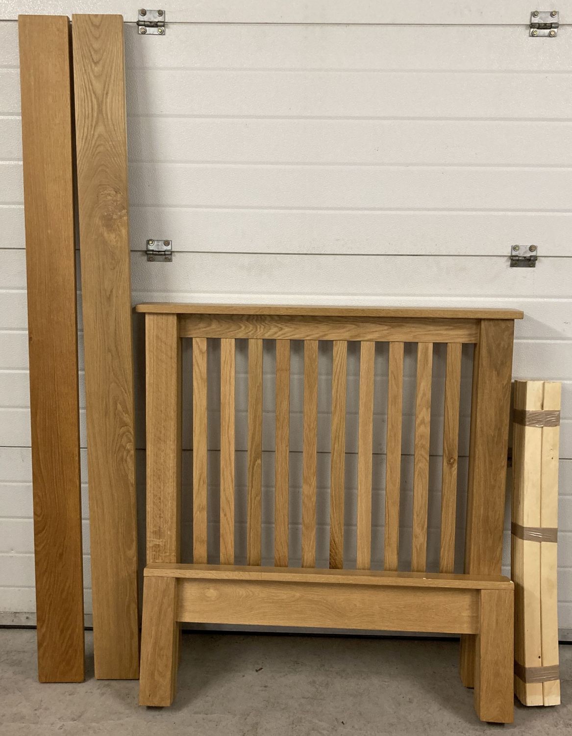 A modern design light oak solid wood single bed frame complete with wooden slats.