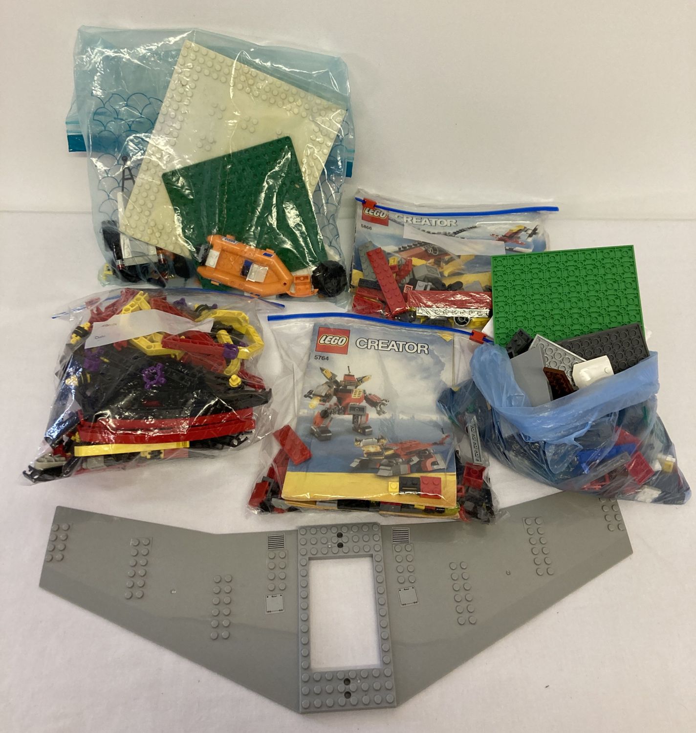 A collection of assorted Lego pieces and play sets.