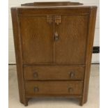 A vintage dark oak tallboy with 2 drawers and 2 door cupboard.