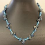 A 16" drilled apatite and blue glass beaded necklace with silver tone T bar clasp.