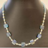 A 15" Kyanite, freshwater pearl and blue glass beaded necklace with silver T bar clasp.