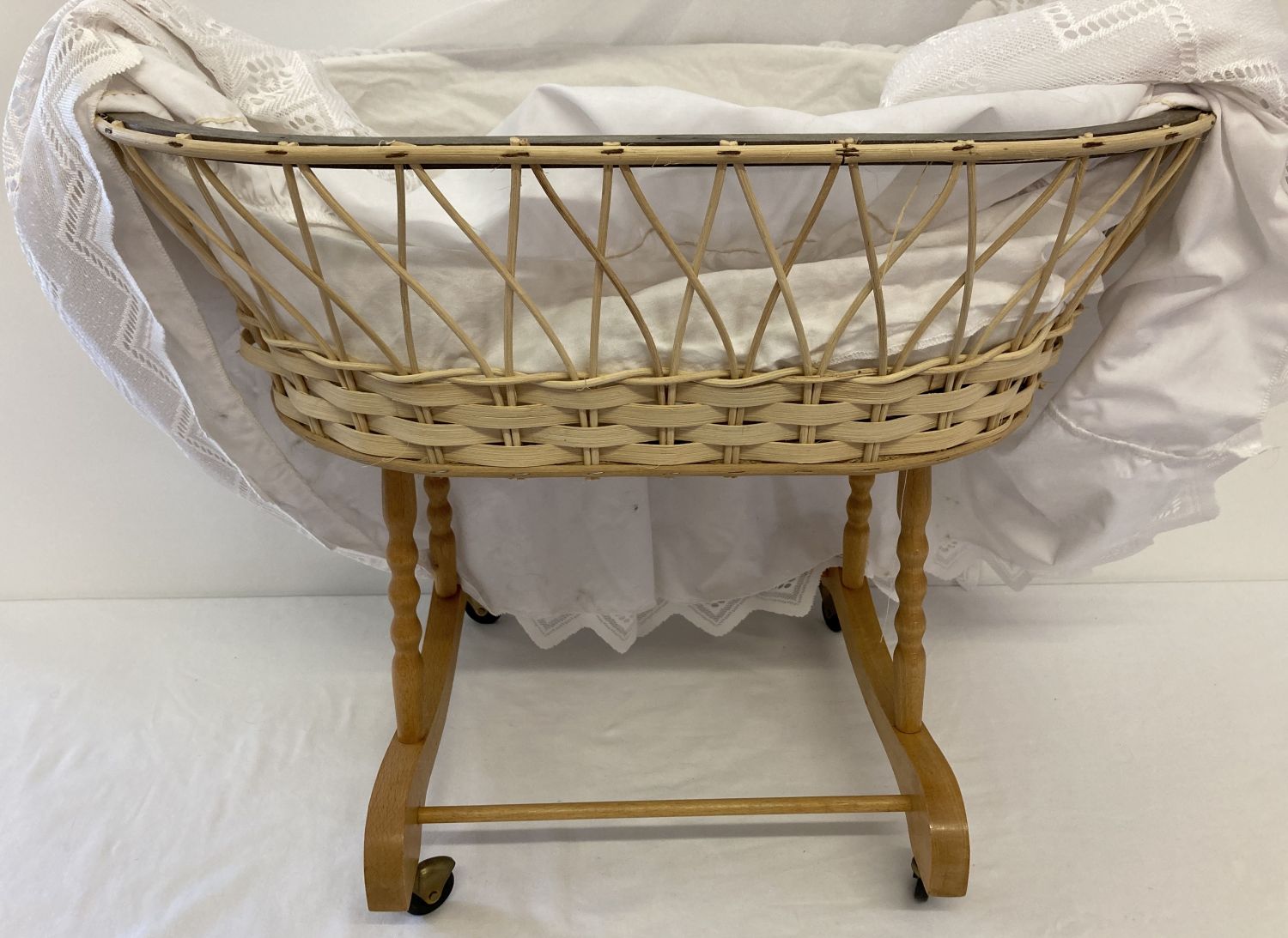 A modern wood and cane dolls crib on wheeled base. Complete with bedding and hanging drapes. - Image 3 of 3
