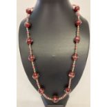 A 26" costume jewellery necklace made from red coloured Venetian style glass beads.
