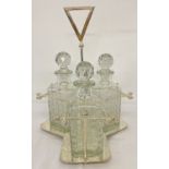 A silver plated triple decanter stand tantalus with 3 cut glass decanters.