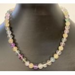 A fine, coloured fluorite beaded necklace with silver lobster claw clasp.