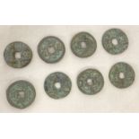 A collection of 8 assorted Chinese coins with square shaped holes.