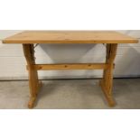 A modern pine refectory style table with metal bracket supports. Obtained from a local public hou…