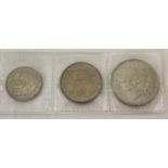 A half silver George VI half crown, two shilling and one shilling coin, all dated 1945. …