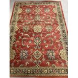 A modern Ziegler floral patterned rug. Red ground with black, blue, beige and green design. Appr…