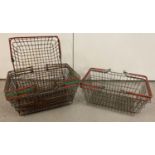 6 vintage wire shopping baskets with red and green plastic grip handles. …