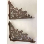 A pair of rust effect cast metal wall shelf bracelets, with decorative scroll & leaf design. Appr…
