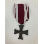 A modern copy of the Polish Cross Of Valour Medal on maroon and white ribbon. …