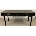 A large painted black wooden desk/buffet table with 2 drawers and pull out rests. Brass handles t…