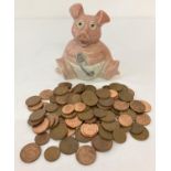 A ceramic "Woody" baby pig money box by Wade containing a quantity of British 2 and 1 pence coins…