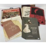 A collection of assorted vintage records and sheet music. …