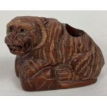 A Japanese wooden carved pot in the form of a wild cat. Set with small signed mother of pearl dis…