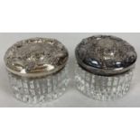2 silver topped cut clear glass pots with push on lids, marked 'Sterling'. Each approx. 6.5cm dia…