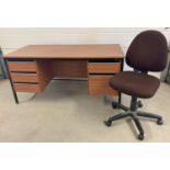 A 1980's wood effect knee hole pedestal desk with drawers, by Jones and Bradburn. 3 small drawers…