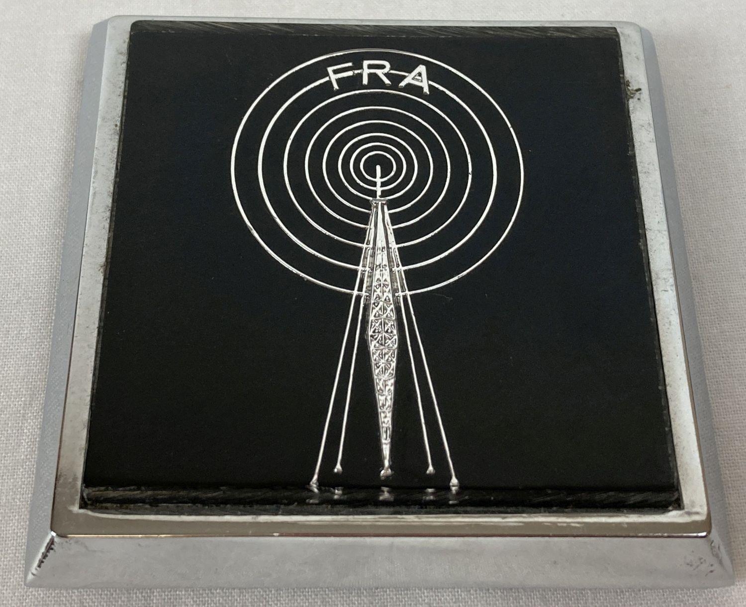 A Free Radio Association car badge with fixings. Radio tower detail with FRA above radio waves. …