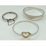 3 silver and silver plated bangles. A child's hinged bangle with diamond cut pattern and safety