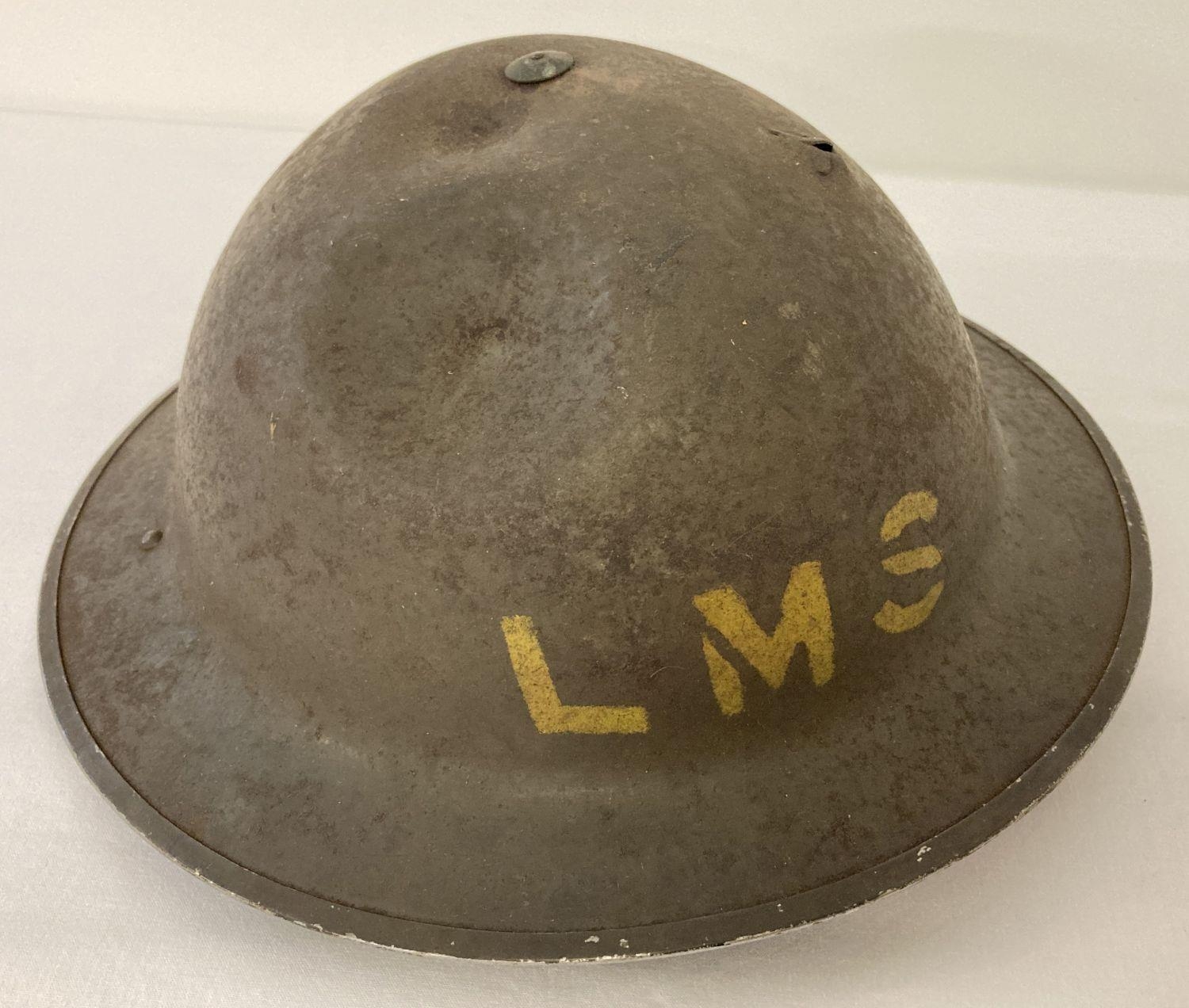 British MkII steel helmet painted khaki with stencilled 'LMS' (London Midland Scottish Railway).