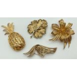 4 vintage gold tone brooches in various designs and sizes to include Trifari abstract brooch and