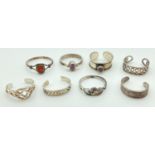 A collection of 6 silver and white metal toe rings together with 2 child's white metal dress