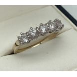 A Gold on silver half eternity ring set with 5 round cut clear stones. Inside of band marked 925.