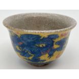 A Chinese crackle glaze ceramic tea bowl. Yellow ground with blue dragon & phoenix design to outer