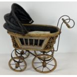 A small wood and metal framed antique style dolls pram with jointed folding hood. Approx. 52cm