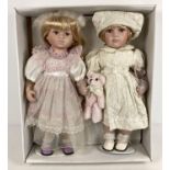 A boxed pair of Leonardo Collectors porcelain dolls. Each doll approx. 20".