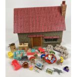 A vintage handmade dolls house with lift off roof complete with a collection of vintage plastic
