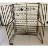 A large antique wrought iron 108 bottle wine rack cage.