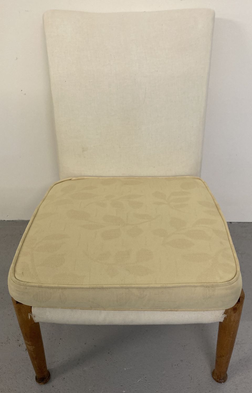 A vintage beach framed low bedroom chair by Parker - Knoll with yellow floral removeable covers.