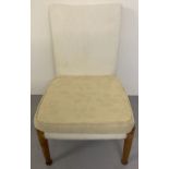A vintage beach framed low bedroom chair by Parker - Knoll with yellow floral removeable covers.