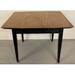A vintage 1960's teak draw leaf kitchen table with veneered top and with ebonised legs and frame.
