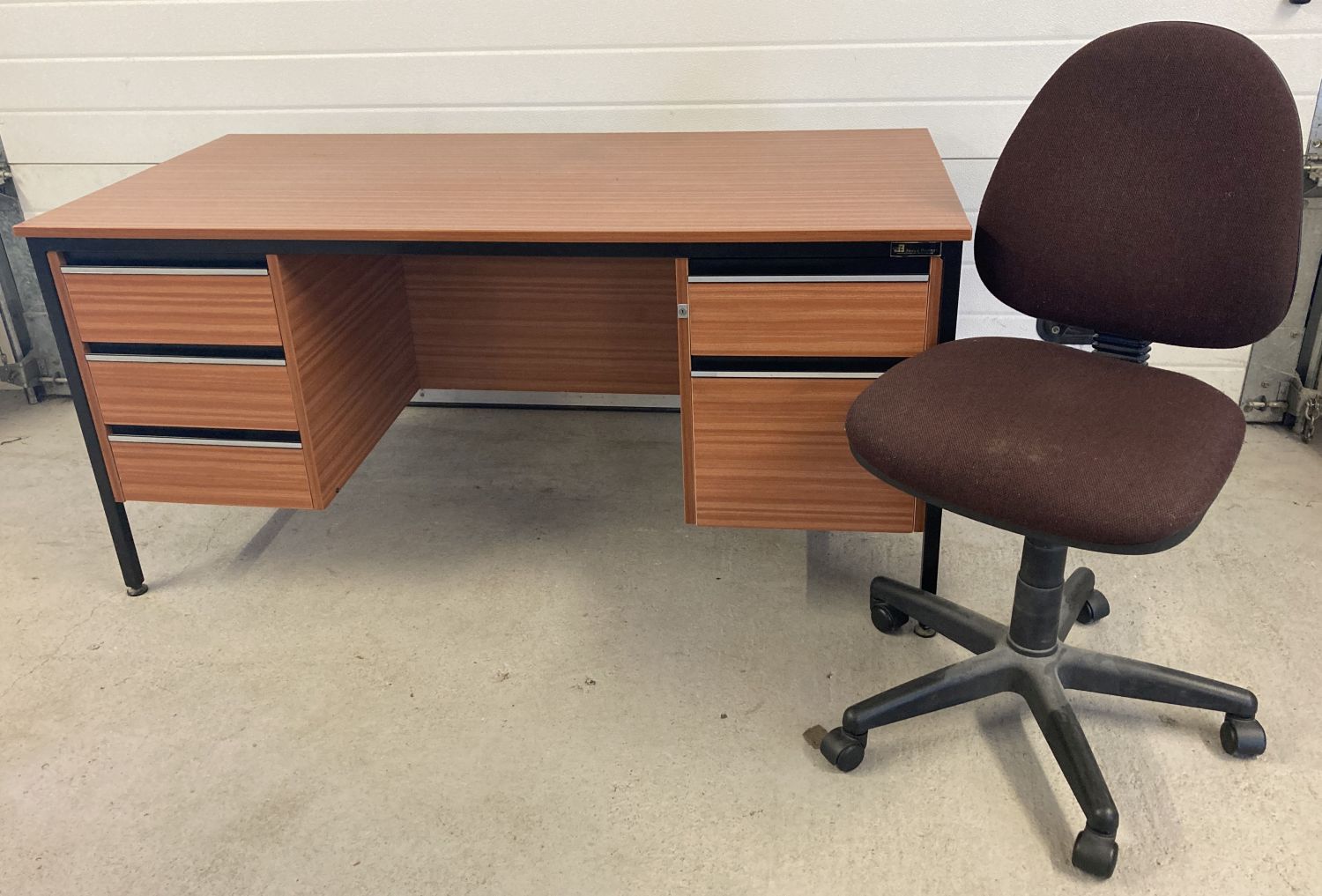 A 1980's wood effect knee hole pedestal desk with drawers by Jones and Bradburn.