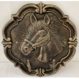 A bronzed effect cast metal wall plaque with horse head design and 2 hooks.