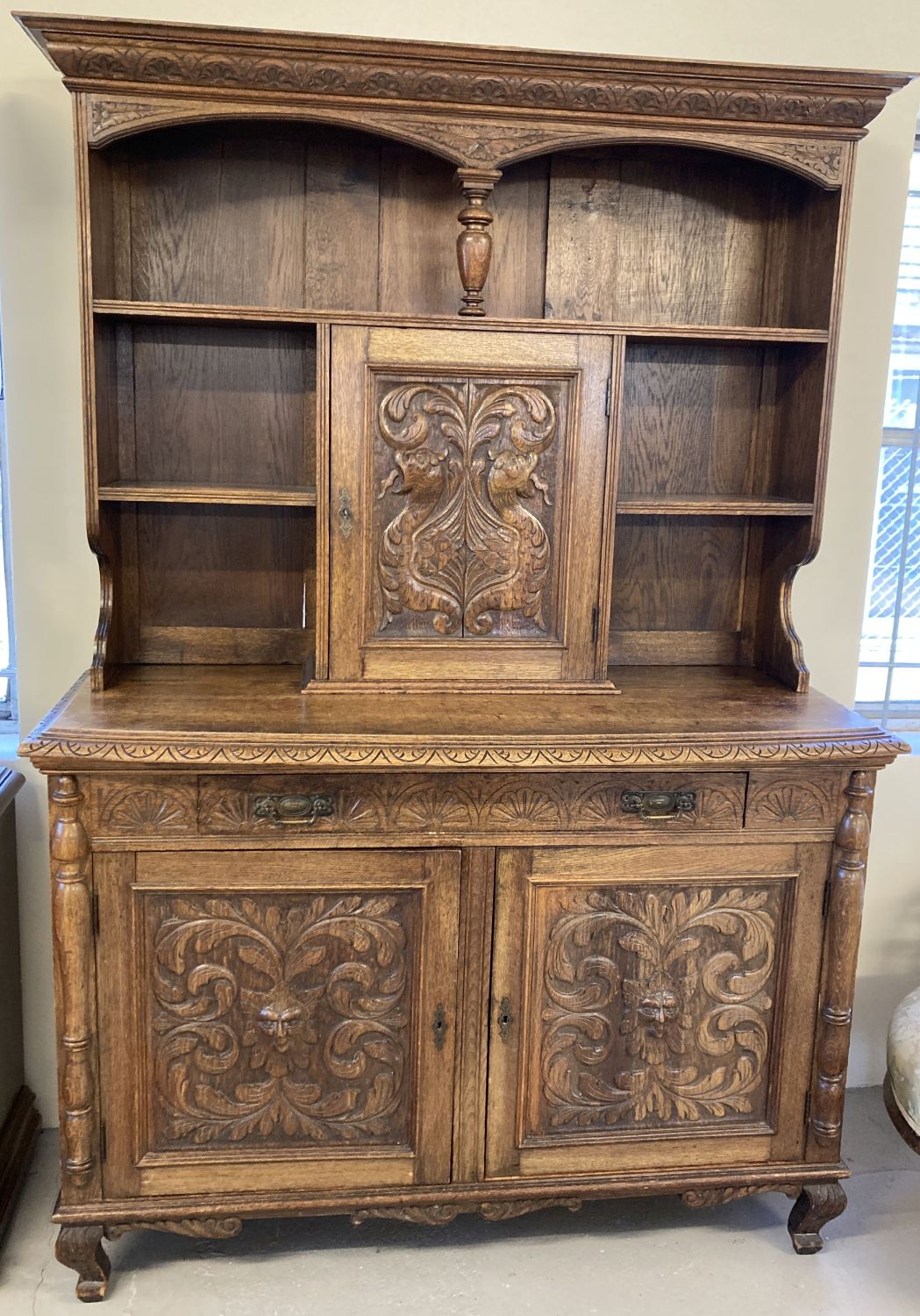 An Antique highly carved medium oak double dresser, possibly French or Dutch.