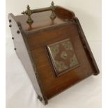 A Victorian mahogany coal scuttle with brass handles.