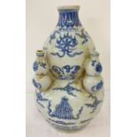 A blue and white Chinese ceramic bottle gourd shaped vase with hand painted detail.