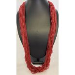 A multi strand coral chip necklace with silver tone hook and eye claps.
